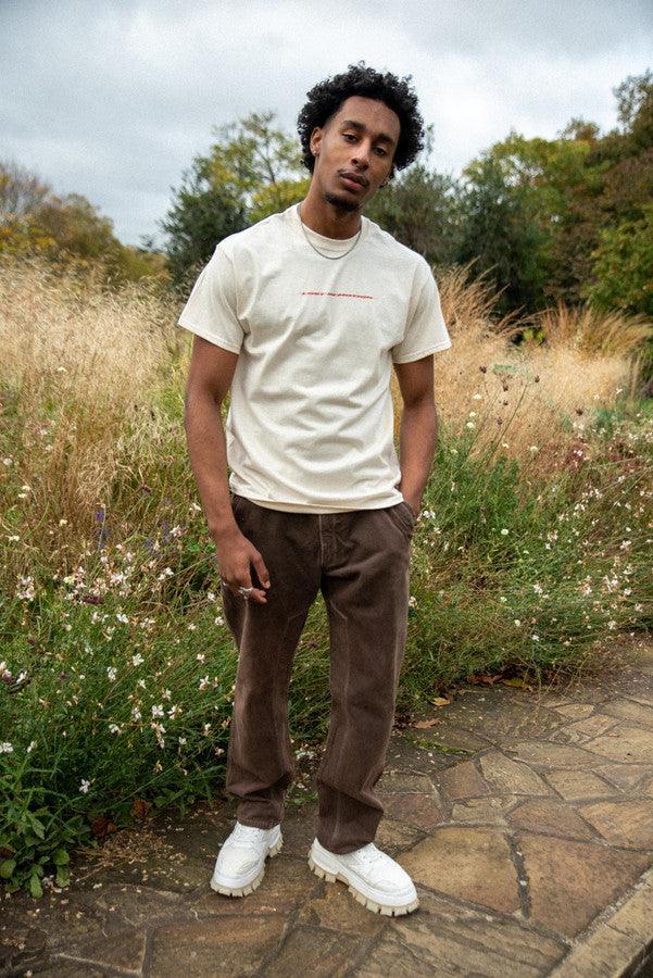 T-Shirt in Neutral With Lost In Motion Logo Print by Dreambutdonotsleep