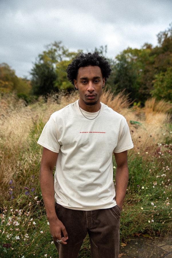 T-Shirt in Neutral With Lost In Motion Logo Print by Dreambutdonotsleep