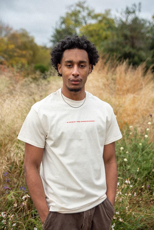 T-Shirt in Neutral With Lost In Motion Logo Print by Dreambutdonotsleep